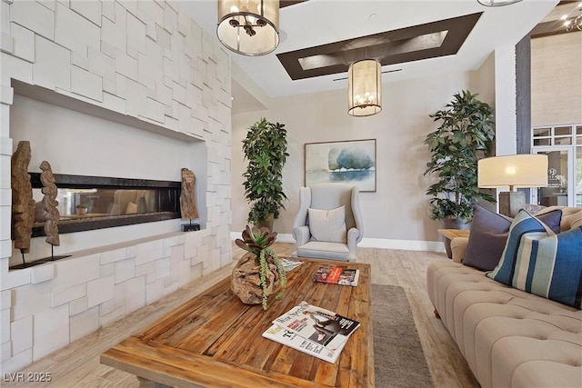 723 Orange Plume Walk Unit 0, Henderson, NV 89011 - living area with an inviting chandelier, baseboards, a multi sided fireplace, and wood finished floors
