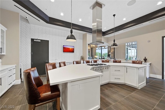 723 Orange Plume Walk Unit 0, Henderson, NV 89011 - kitchen featuring stainless steel gas stovetop, light countertops, an accent wall, and island range hood