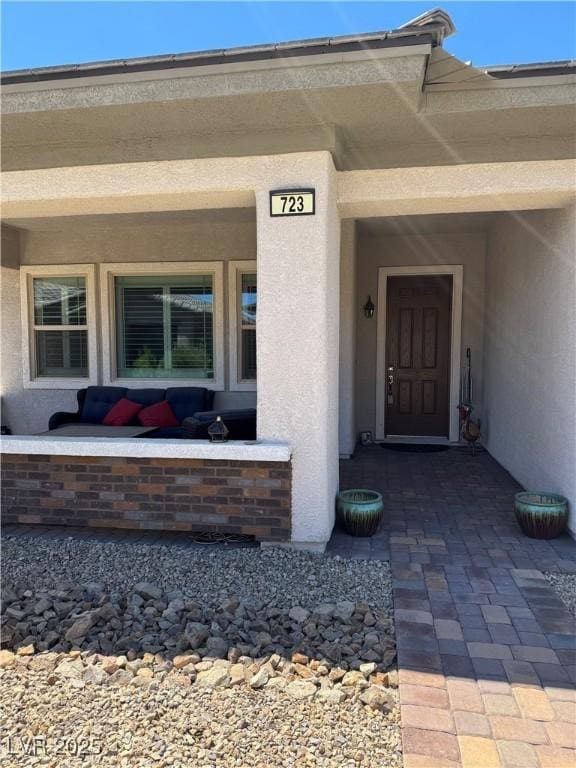 723 Orange Plume Walk Unit 0, Henderson, NV 89011 - doorway to property with stucco siding and a porch