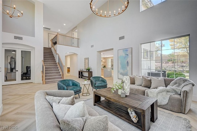 living room with light parquet floors and a chandelier