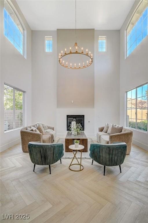 living room with an inviting chandelier and light parquet floors