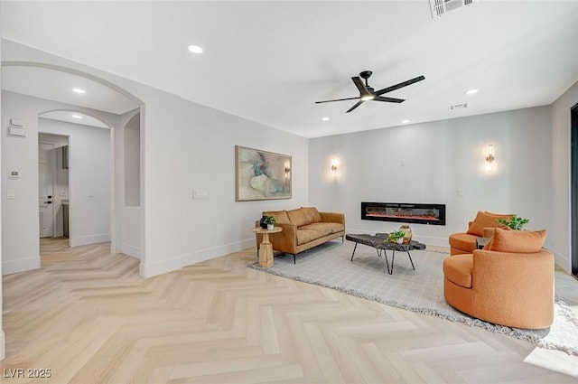 living room with light parquet flooring and ceiling fan