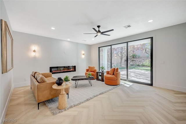 living room with ceiling fan and light parquet flooring