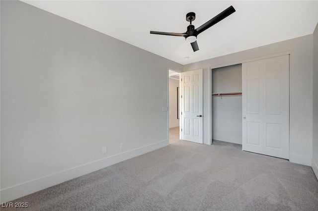 unfurnished bedroom featuring ceiling fan, light colored carpet, and a closet