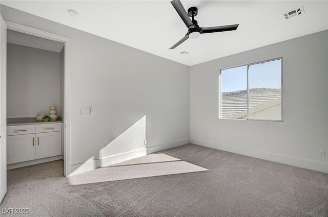 carpeted empty room with ceiling fan