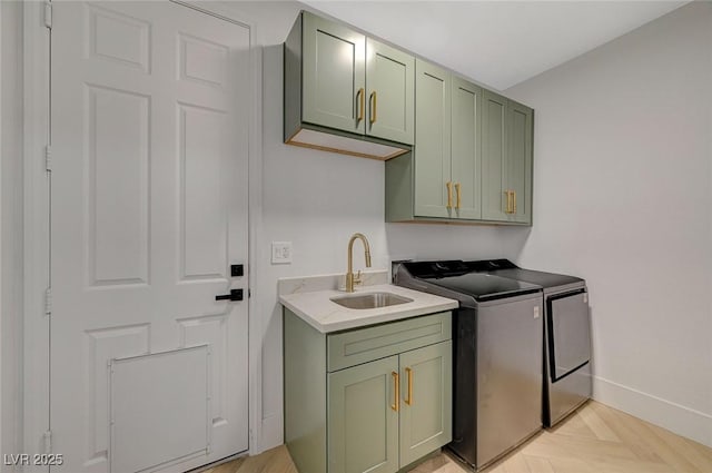 clothes washing area featuring cabinets, light parquet flooring, sink, and washing machine and clothes dryer