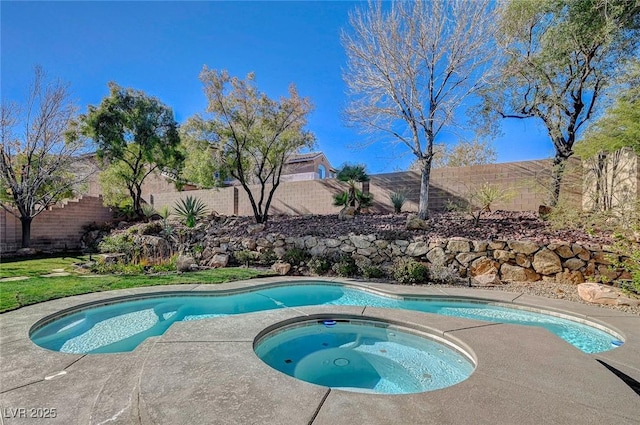 view of swimming pool featuring an in ground hot tub