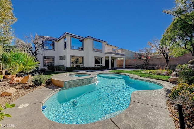 view of swimming pool featuring an in ground hot tub