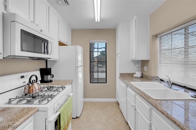 4861 S Torrey Pines Dr Unit 201, Las Vegas, NV 89103 - kitchen featuring white appliances, a sink, baseboards, white cabinetry, and light countertops