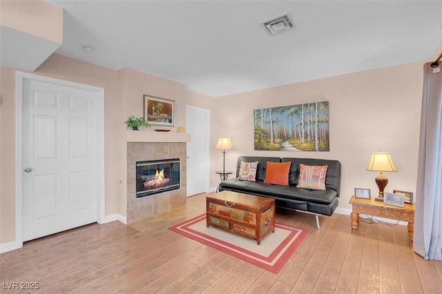 4861 S Torrey Pines Dr Unit 201, Las Vegas, NV 89103 - living area with wood finished floors, a fireplace, and baseboards