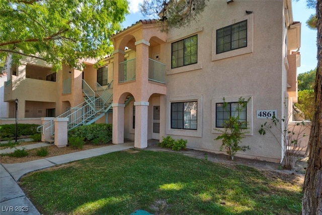 4861 S Torrey Pines Dr Unit 201, Las Vegas, NV 89103 - view of front of home featuring stucco siding, a front yard, and stairs