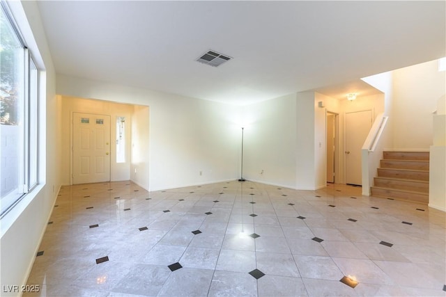 tiled spare room featuring plenty of natural light