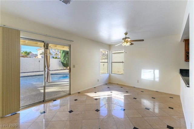 unfurnished living room featuring light tile patterned floors and ceiling fan