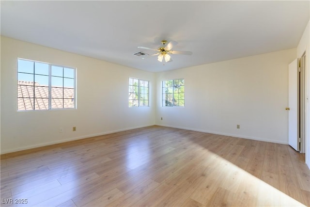 empty room featuring ceiling fan and light hardwood / wood-style flooring