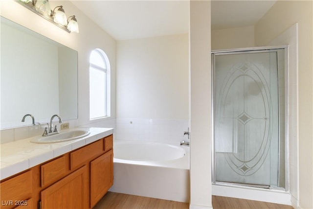 bathroom featuring independent shower and bath and vanity