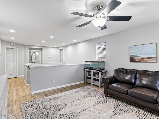 living room with ceiling fan and light hardwood / wood-style floors