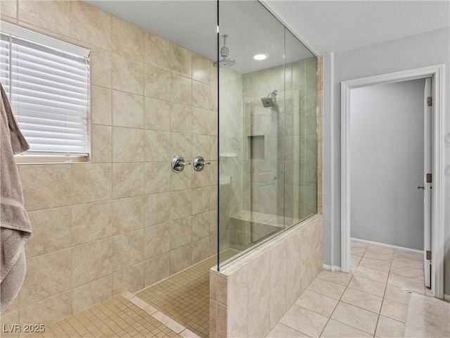 bathroom featuring a tile shower and tile patterned floors