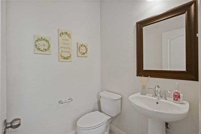 bathroom featuring toilet and sink