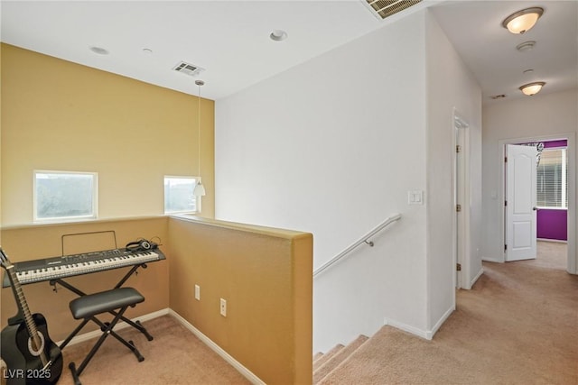 miscellaneous room with light colored carpet