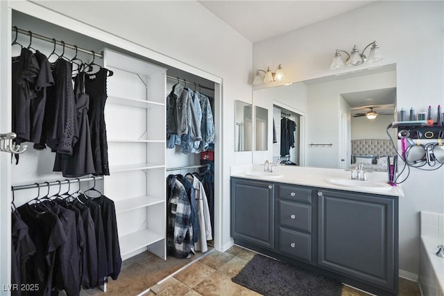 bathroom featuring ceiling fan and vanity