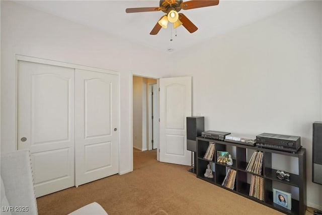 interior space with light carpet and ceiling fan