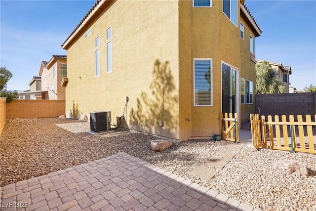 exterior space with cooling unit and a patio area