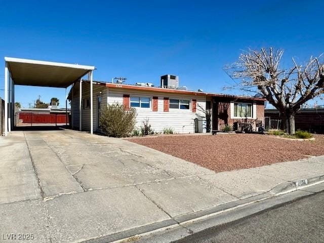 ranch-style home featuring a carport