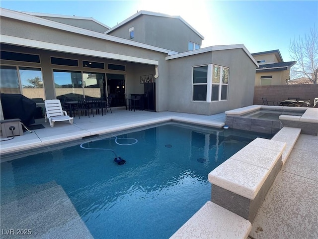 view of pool featuring an in ground hot tub, a grill, and a patio area