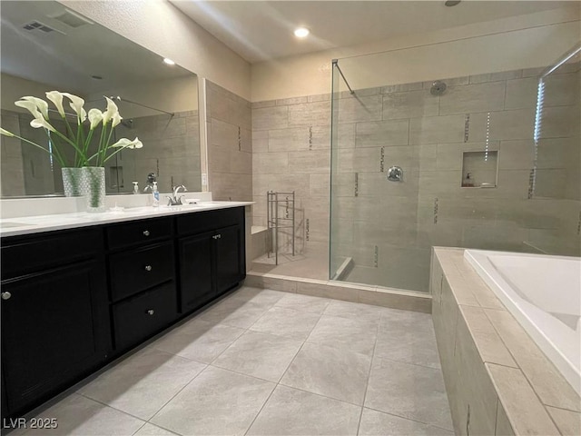 bathroom featuring tile patterned flooring, vanity, and plus walk in shower