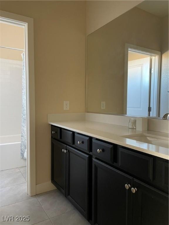 bathroom featuring tile patterned flooring, vanity, and shower / bath combo with shower curtain