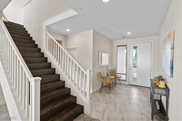 foyer entrance featuring stairway, baseboards, visible vents, and recessed lighting