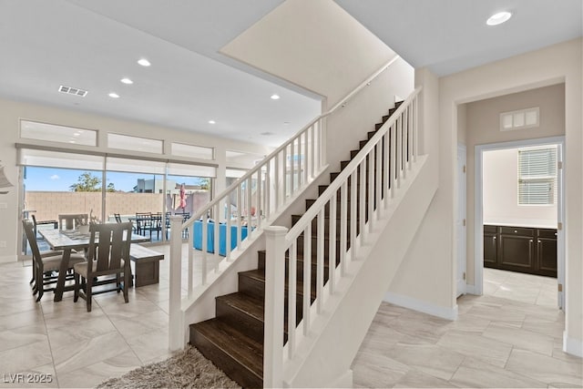 staircase with recessed lighting, visible vents, and baseboards