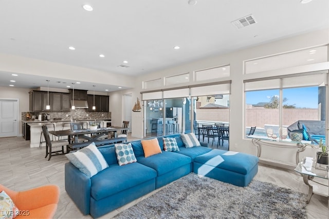 living room with recessed lighting and visible vents