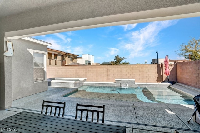 view of swimming pool with a pool with connected hot tub, a fenced backyard, and a patio