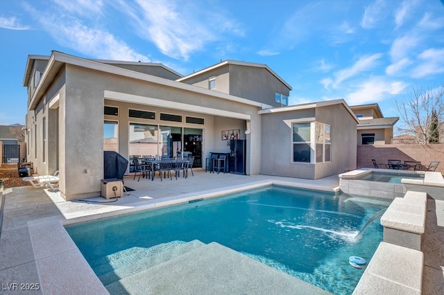 view of swimming pool featuring a patio, fence, and a pool with connected hot tub