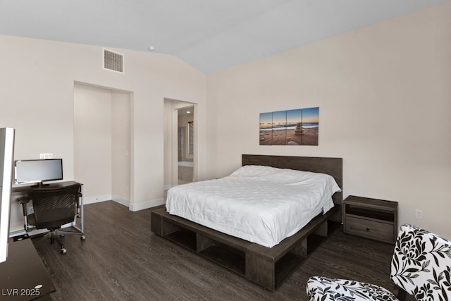 bedroom featuring vaulted ceiling, dark wood finished floors, visible vents, and baseboards