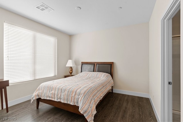 bedroom with dark wood-style floors, baseboards, and visible vents