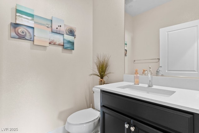 bathroom with toilet and vanity