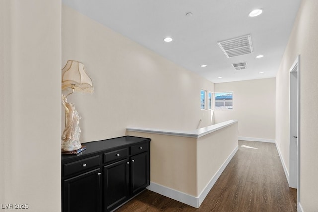 hall featuring recessed lighting, visible vents, dark wood-type flooring, an upstairs landing, and baseboards