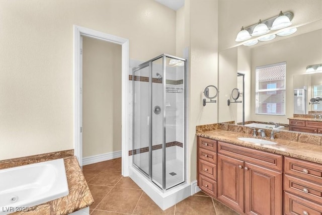 bathroom with tile patterned flooring, shower with separate bathtub, and vanity