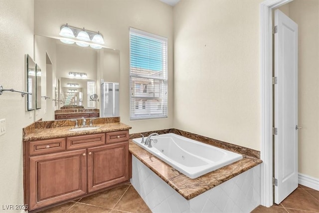 bathroom with tile patterned floors, vanity, and tiled tub