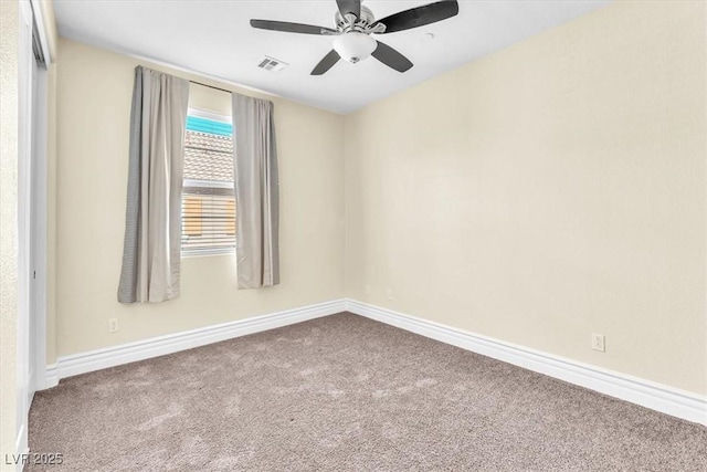 carpeted spare room with ceiling fan