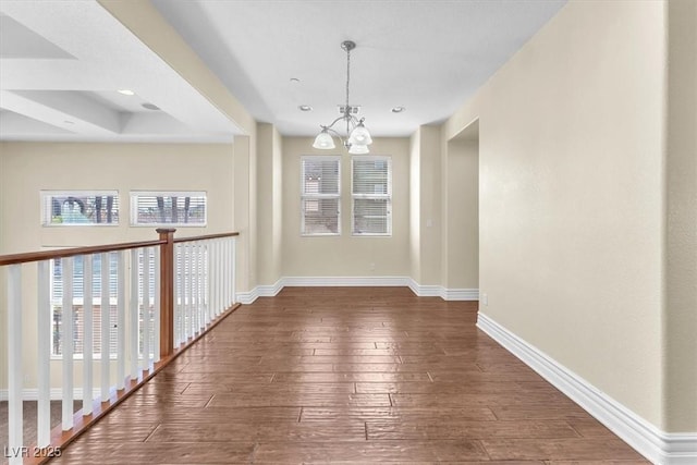 unfurnished dining area with dark hardwood / wood-style flooring and an inviting chandelier