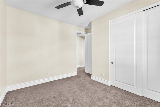 unfurnished bedroom with light colored carpet, ceiling fan, and a closet