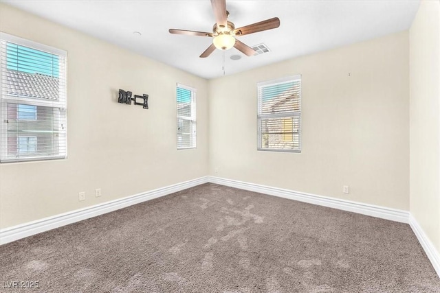 spare room with carpet floors and ceiling fan