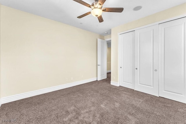 unfurnished bedroom with a closet, ceiling fan, and dark colored carpet