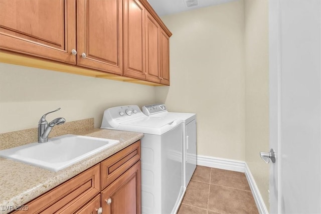 washroom featuring cabinets, sink, light tile patterned floors, and independent washer and dryer