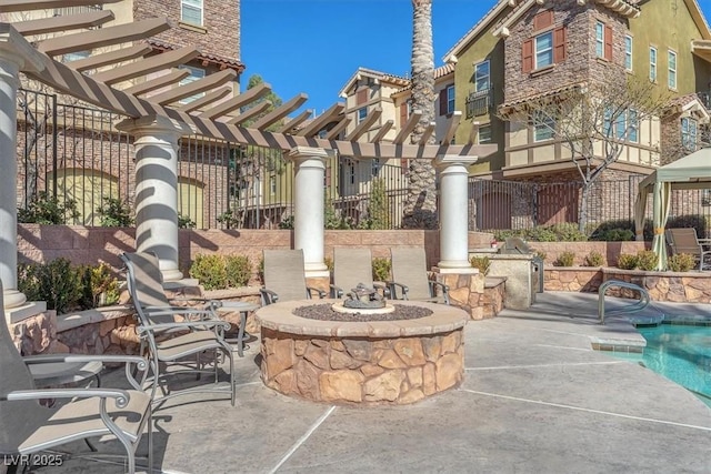 view of patio with a pool, an outdoor fire pit, and a pergola