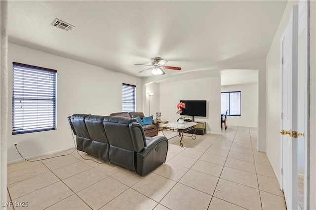 living room with visible vents, a wealth of natural light, and light tile patterned flooring