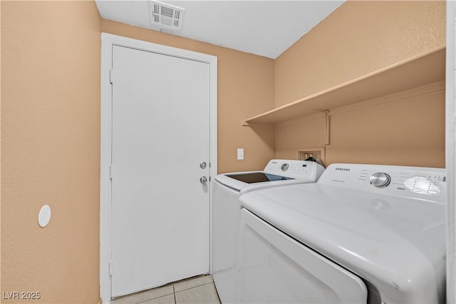 laundry room with laundry area, light tile patterned floors, visible vents, and washer and dryer